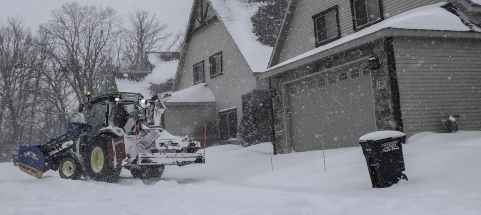 Miller Yard Care & Construction removing snow from a clients home in Minnesota.